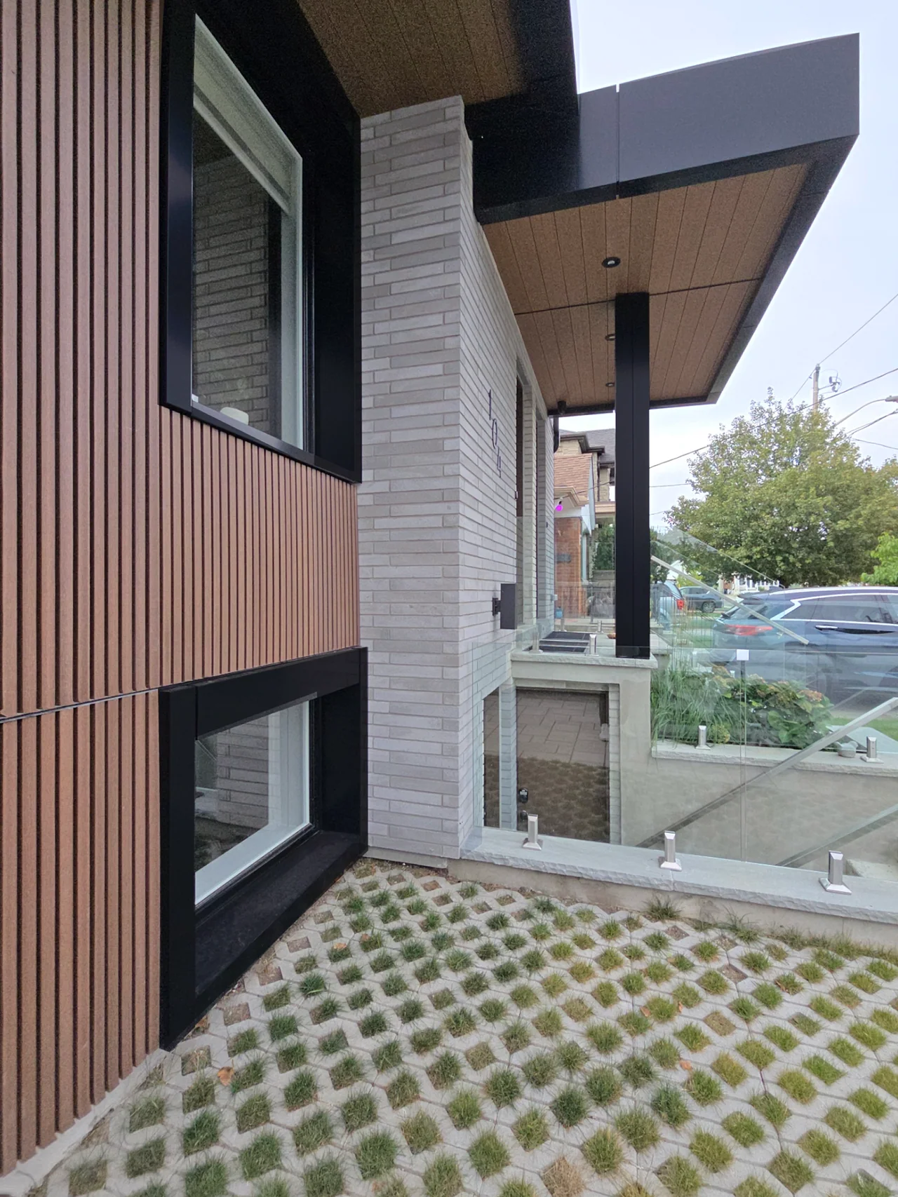 Separate lower-level entrance, glass guards and planted paving at the East York multiplex